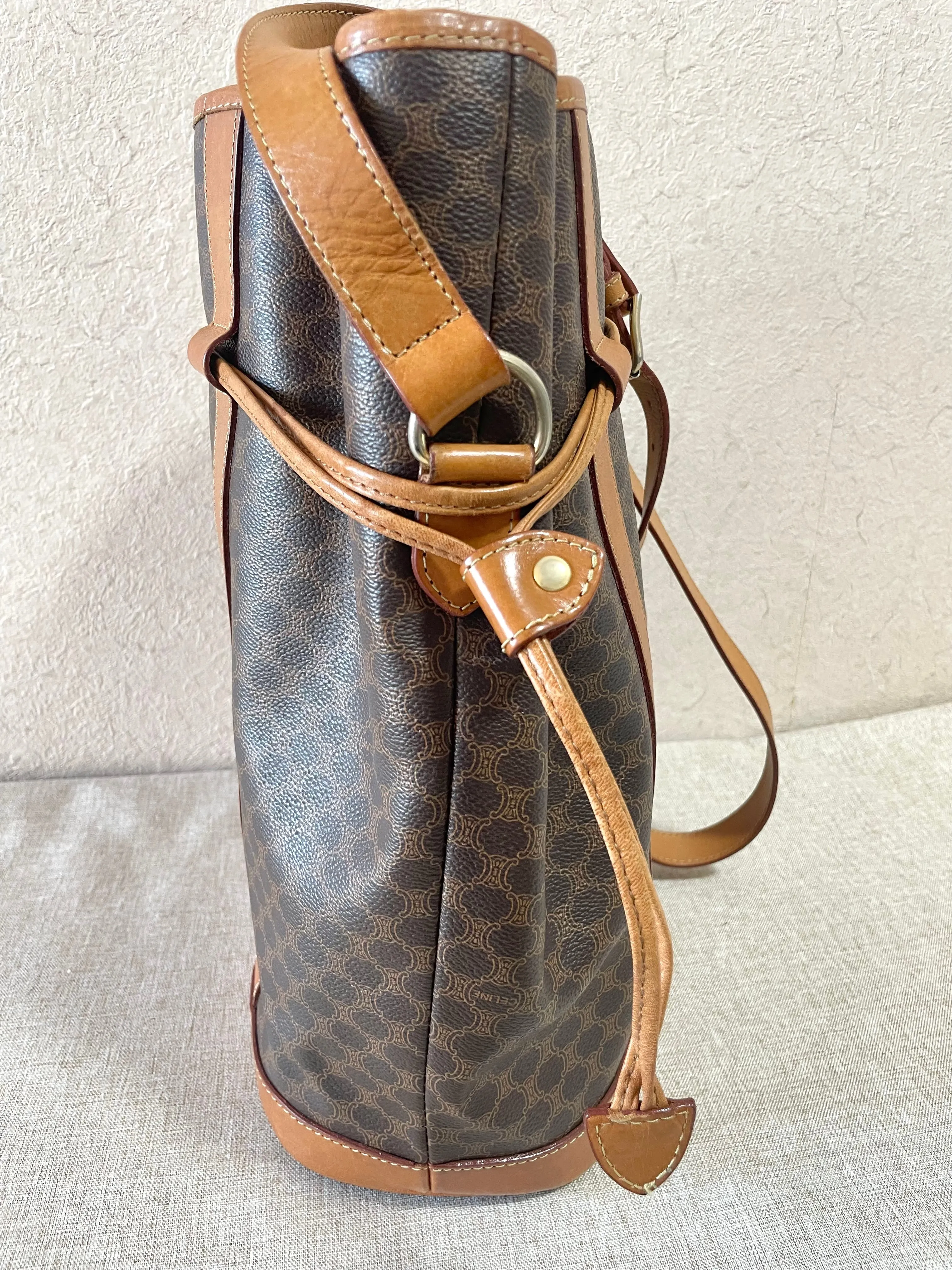 Vintage Celine hobo bucket shoulder bag in classic brown triomphe pattern with leather straps. 070218ys8