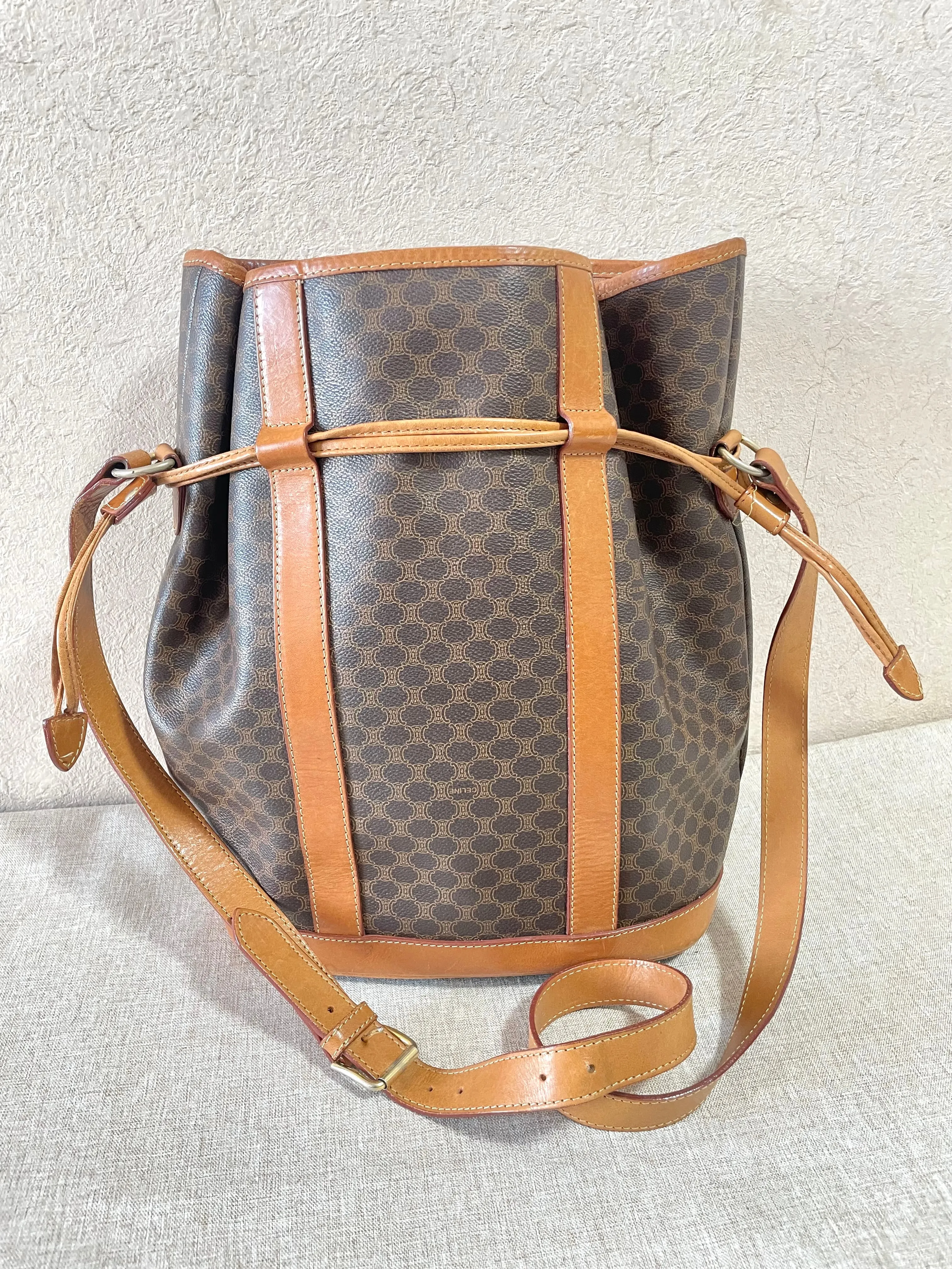 Vintage Celine hobo bucket shoulder bag in classic brown triomphe pattern with leather straps. 070218ys8