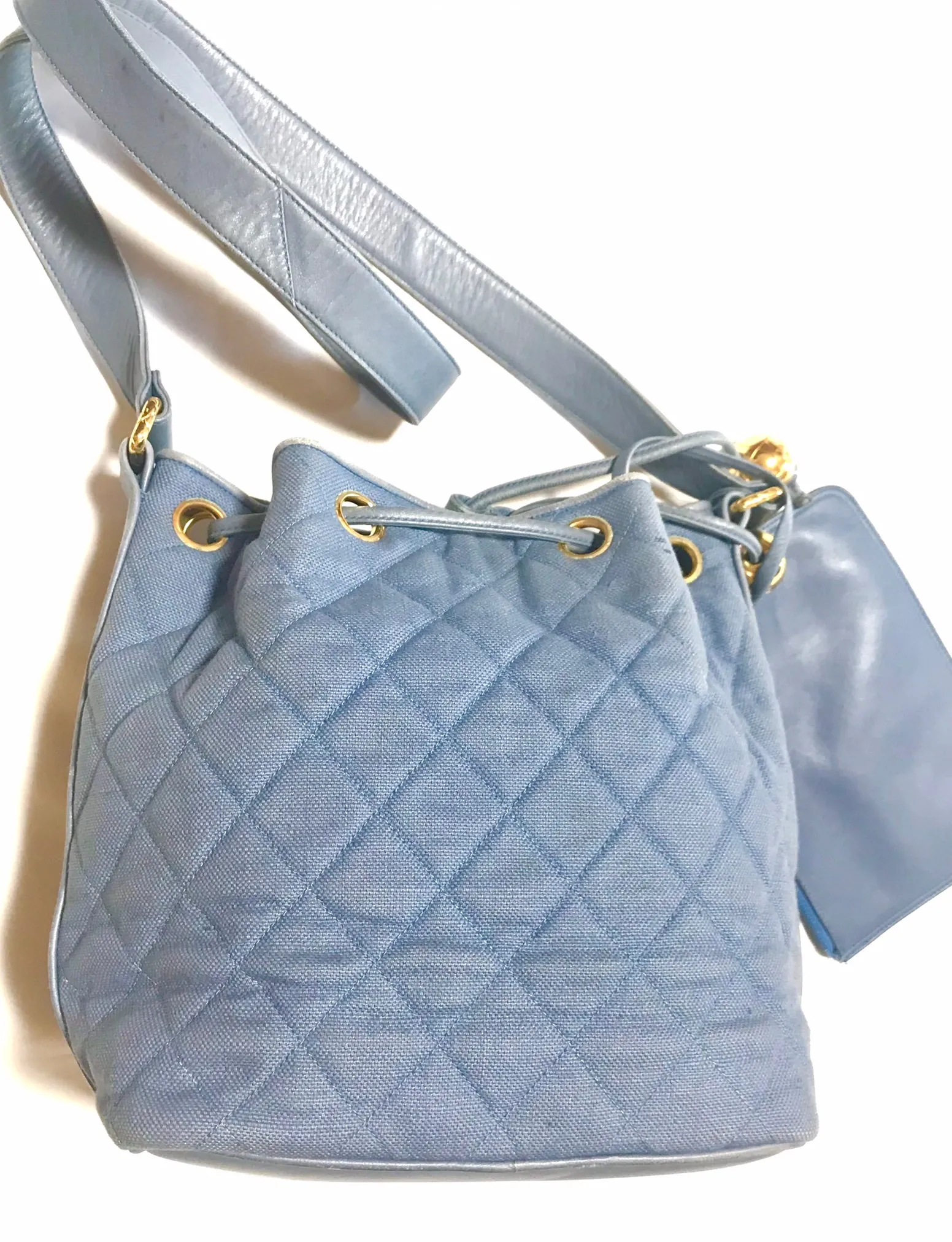 Vintage CHANEL blue quilted canvas and leather combo hobo bucket shoulder bag with drawstrings and golden CC mark balls. 060905r3