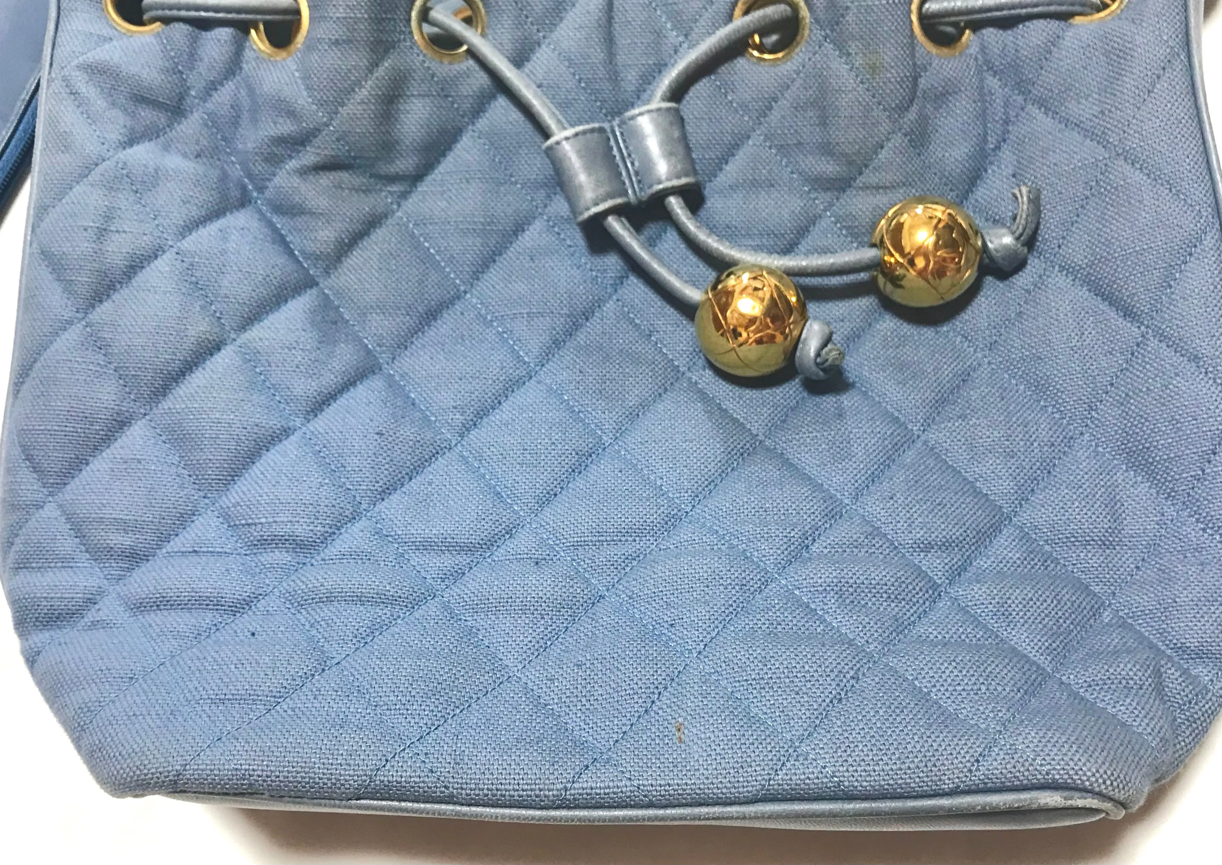 Vintage CHANEL blue quilted canvas and leather combo hobo bucket shoulder bag with drawstrings and golden CC mark balls. 060905r3