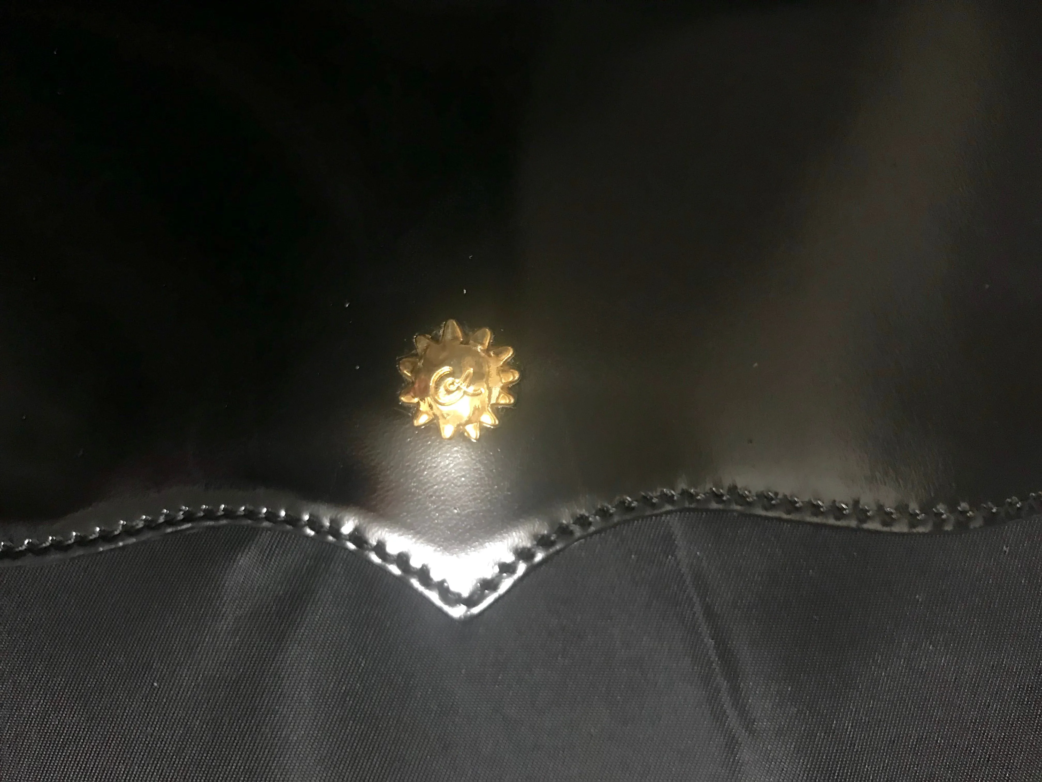 Vintage Christian Lacroix black patent enamel and nylon combo clutch bag with a sun flower shape logo motif.