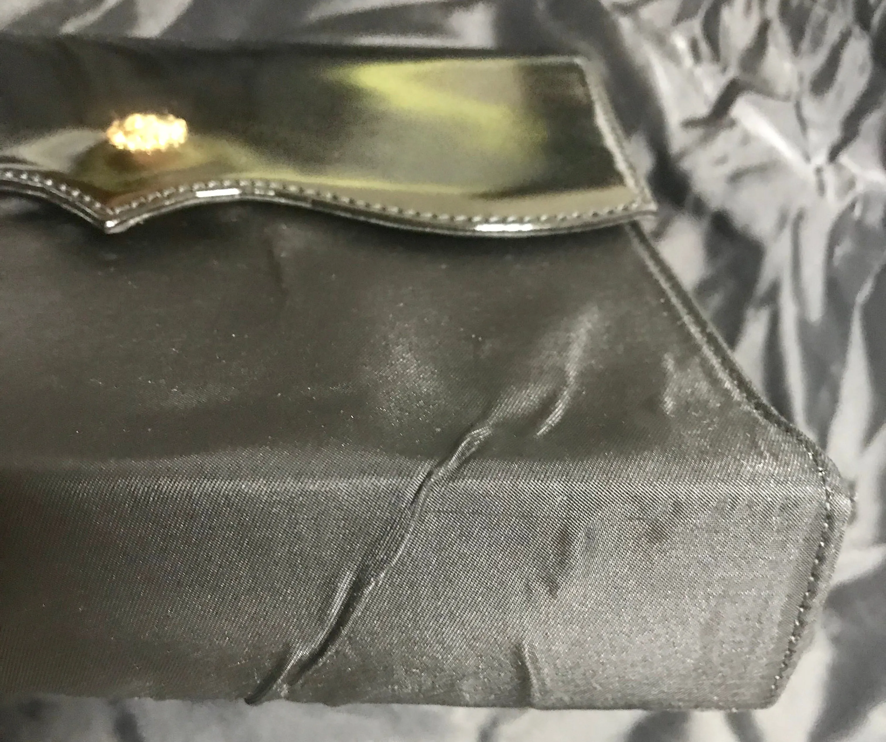 Vintage Christian Lacroix black patent enamel and nylon combo clutch bag with a sun flower shape logo motif.