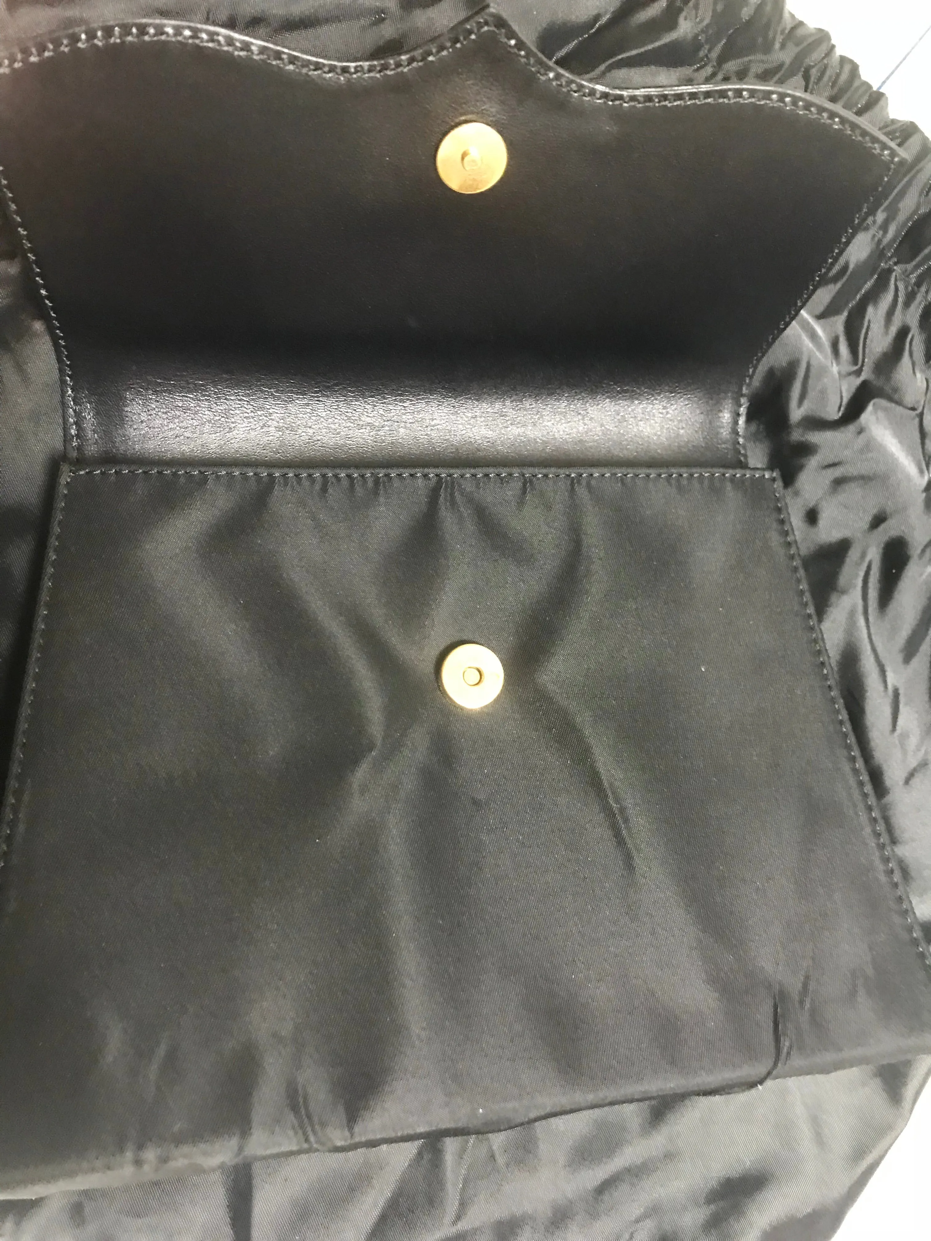 Vintage Christian Lacroix black patent enamel and nylon combo clutch bag with a sun flower shape logo motif.