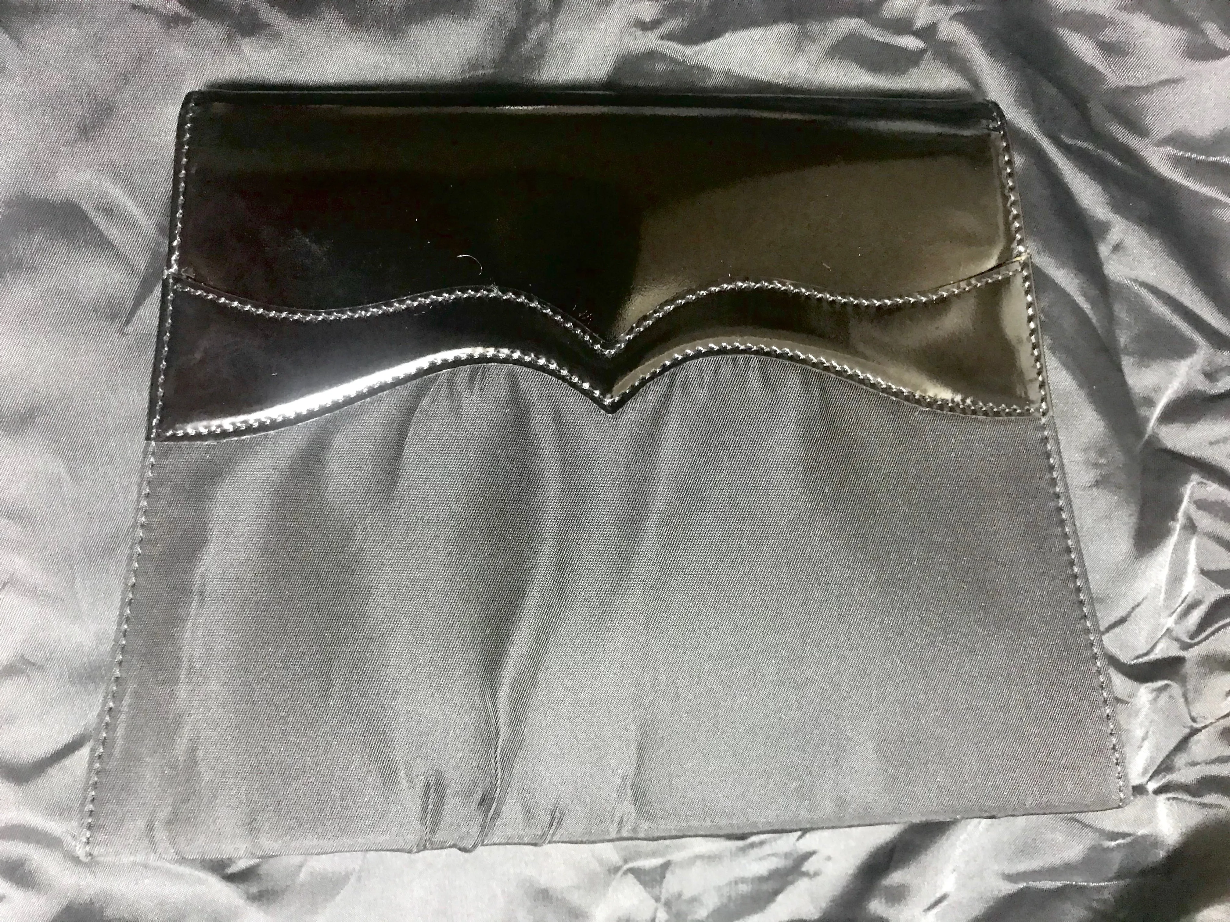 Vintage Christian Lacroix black patent enamel and nylon combo clutch bag with a sun flower shape logo motif.